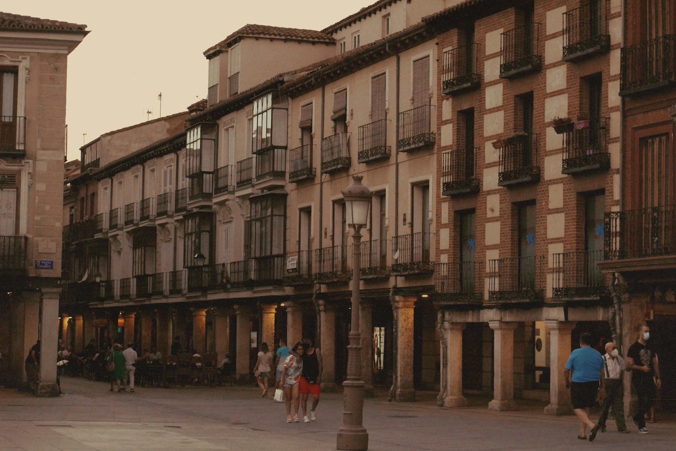 a row of three story buildings next to a sidewalk