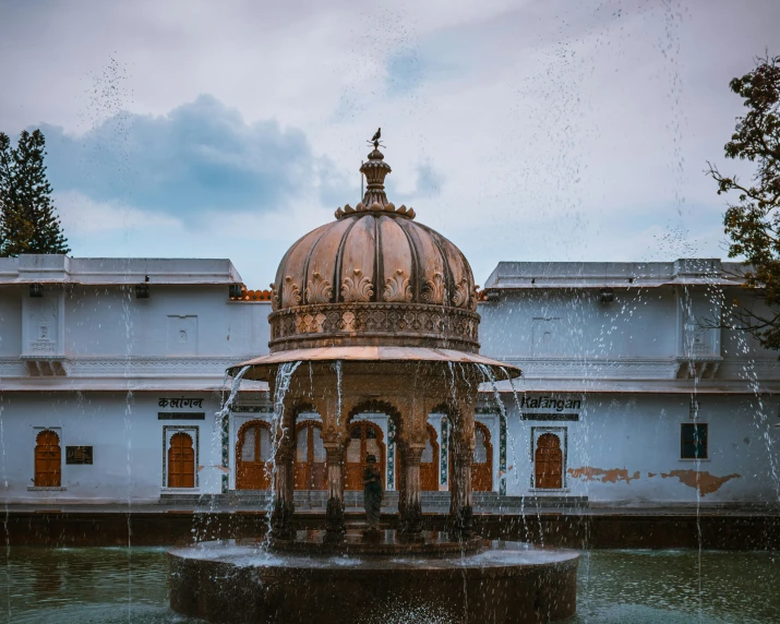 water shoots up from the fountain and onto the house