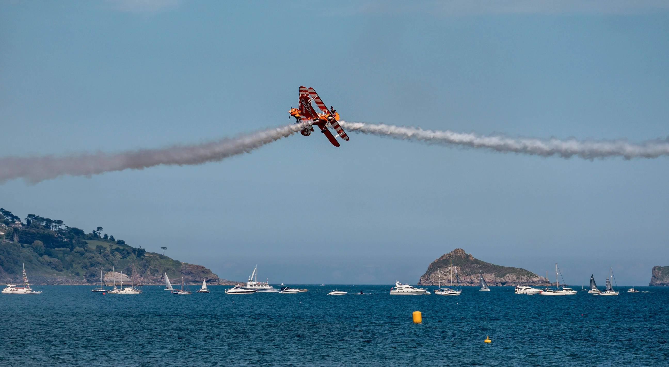 a couple of planes flying by the beach