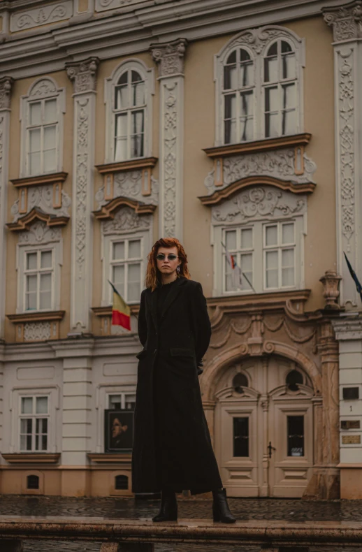 a woman standing in front of a tall building