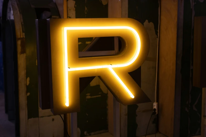 neon light letters sitting up against a wall