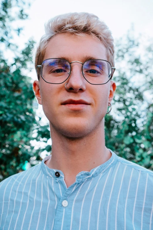 a man in striped shirt with sunglasses and glasses