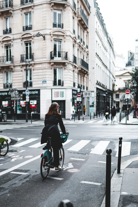 the bicyclist is riding along the street in the city