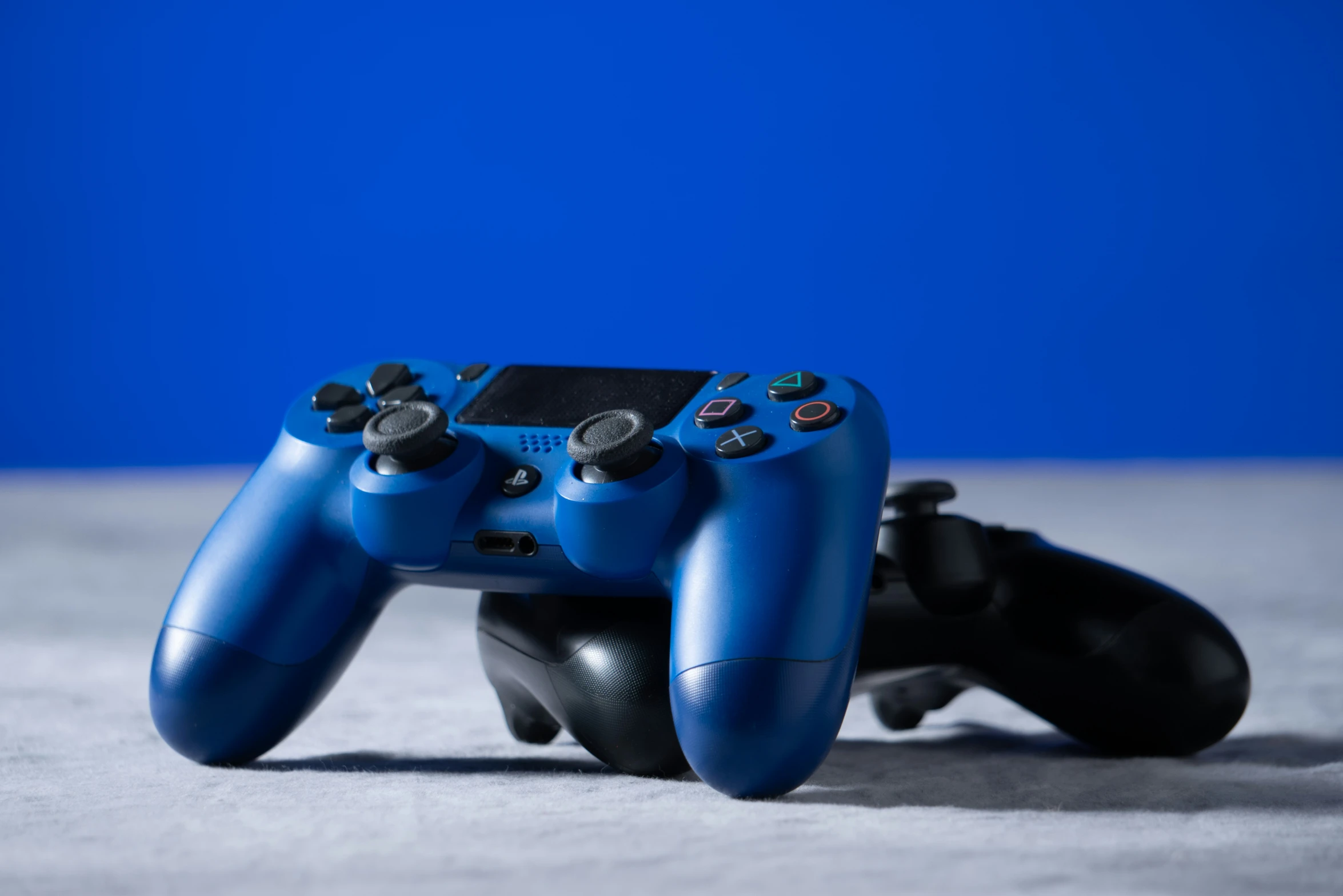 there is a blue controller on a blue surface