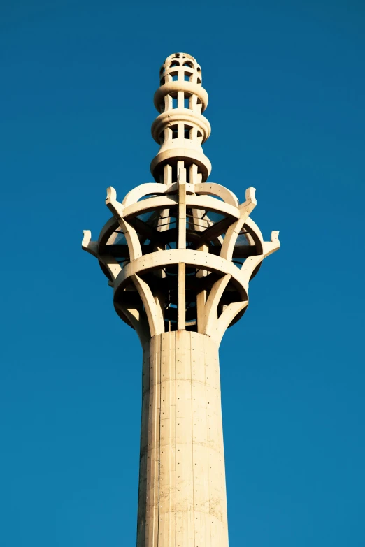 a tall clock tower standing in front of a blue sky