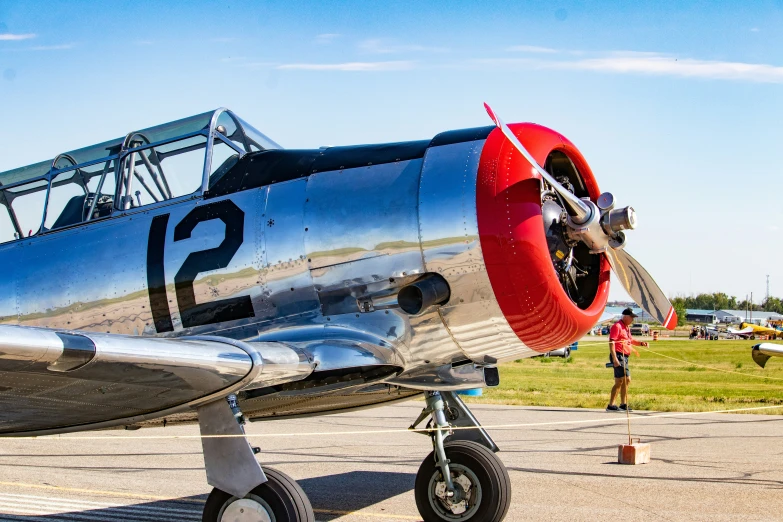 a propeller airplane sitting on top of a runway