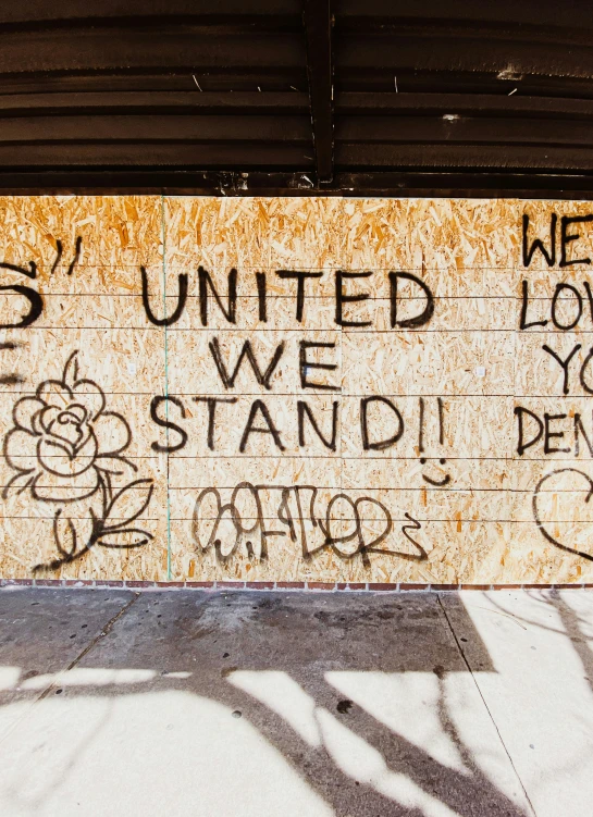 graffiti writing on a sign next to a fire hydrant