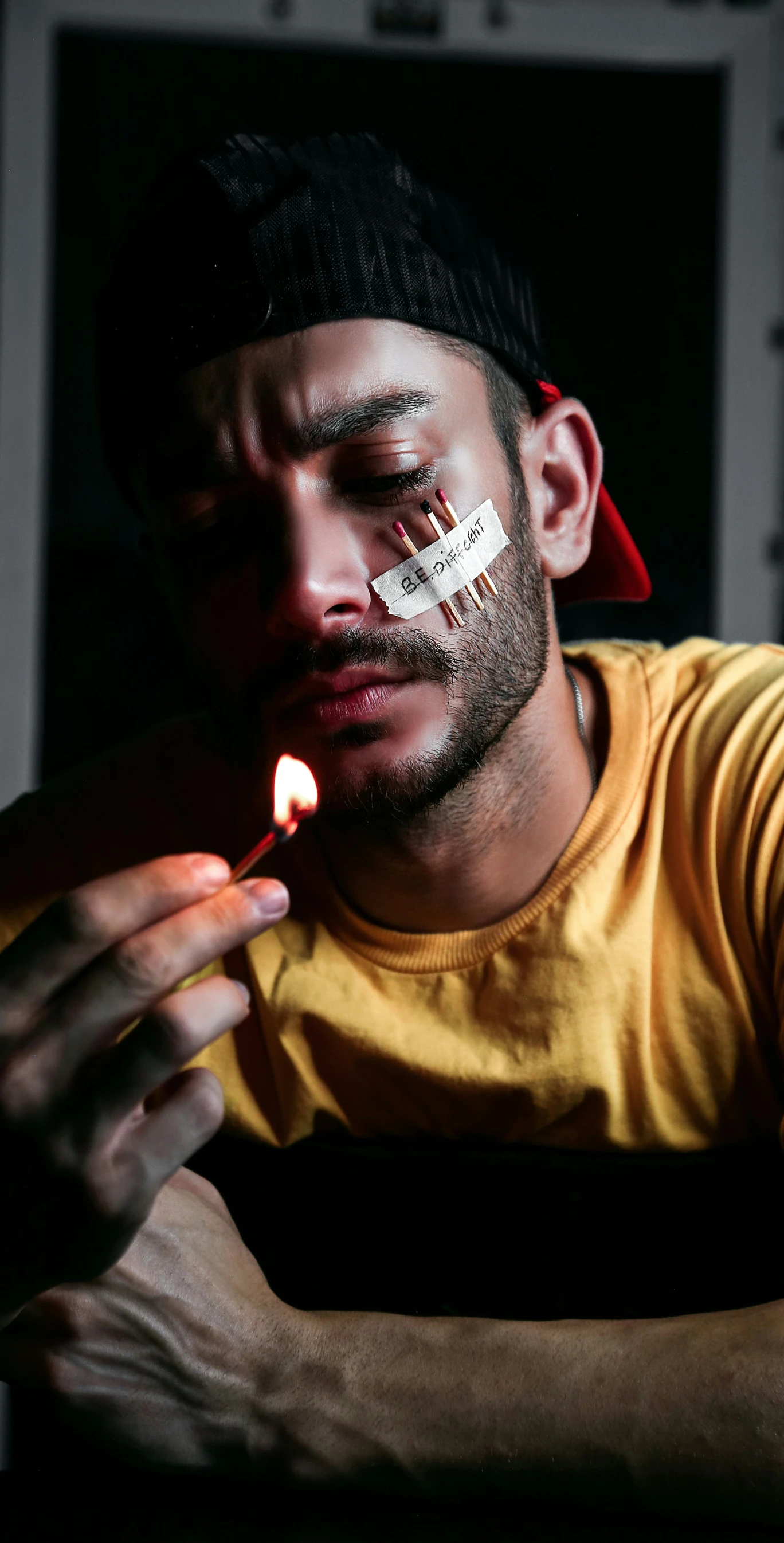 a man smoking a cigarette next to an open window