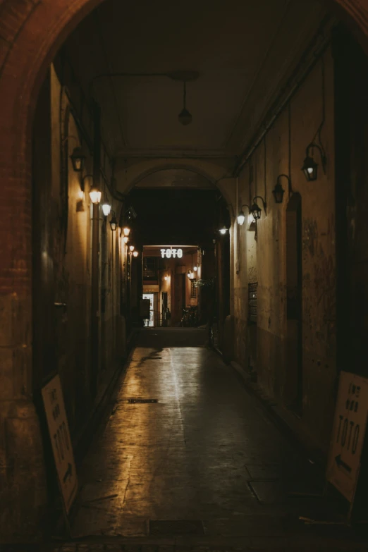 a street that has many lights on a brick wall