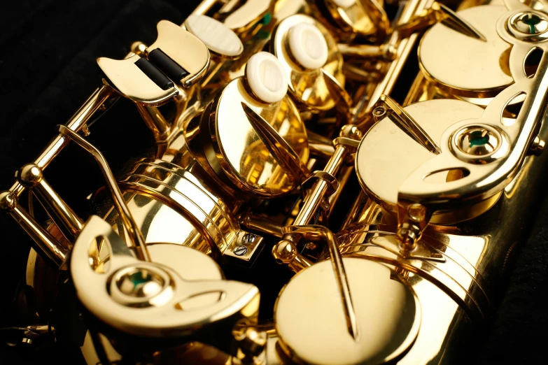 a very shiny gold flute closeup with some of it's parts