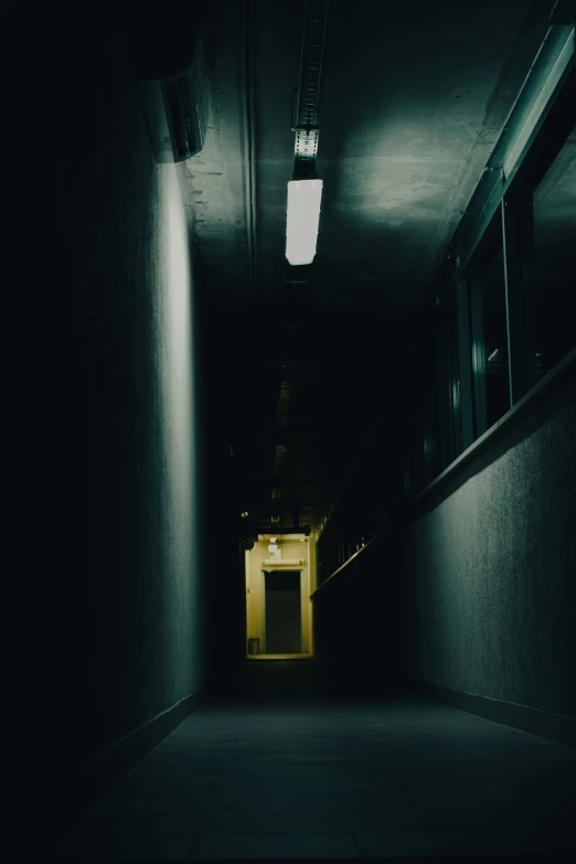 a dark hallway lit by three bright lights