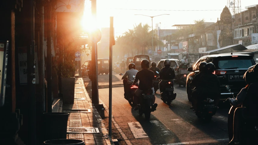 the sun shines brightly behind some motorcyclist's