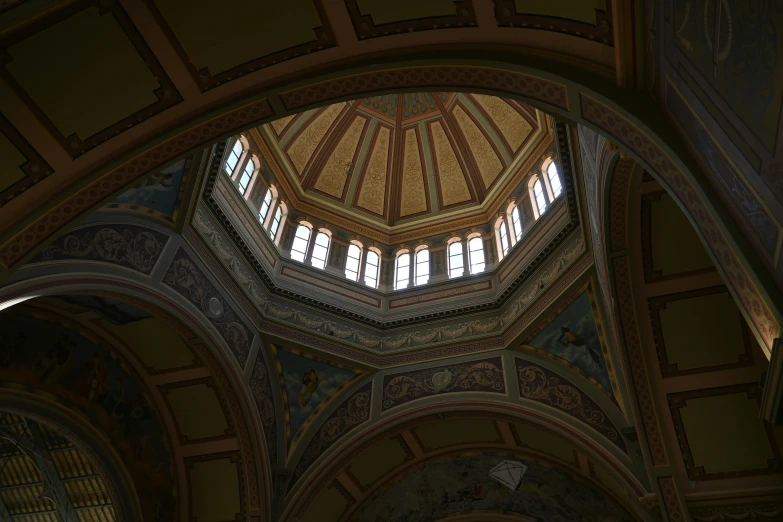 a room with three windows and large arches