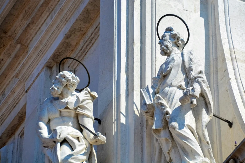 two statues of jesus and mary in front of an old church