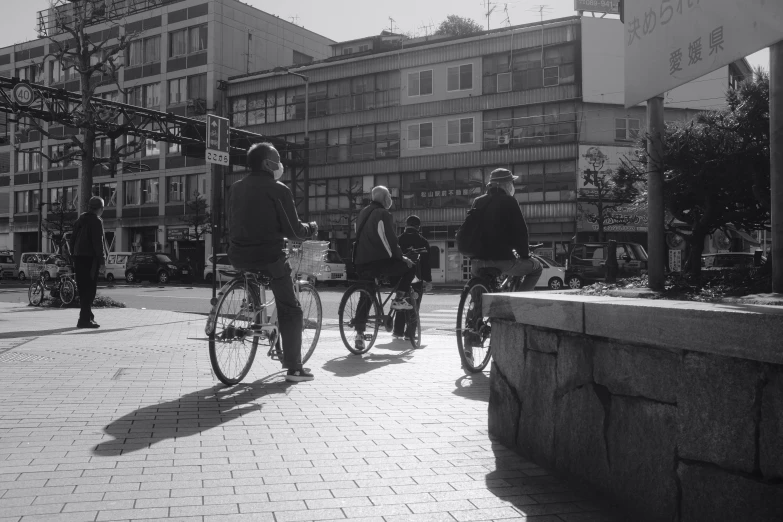 a couple of people on bikes going down a road