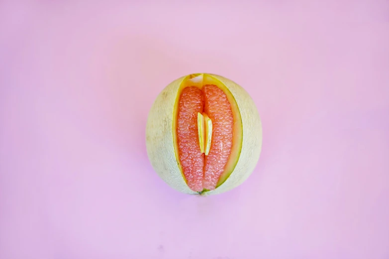 a sliced papaya fruit with a piece already cut out