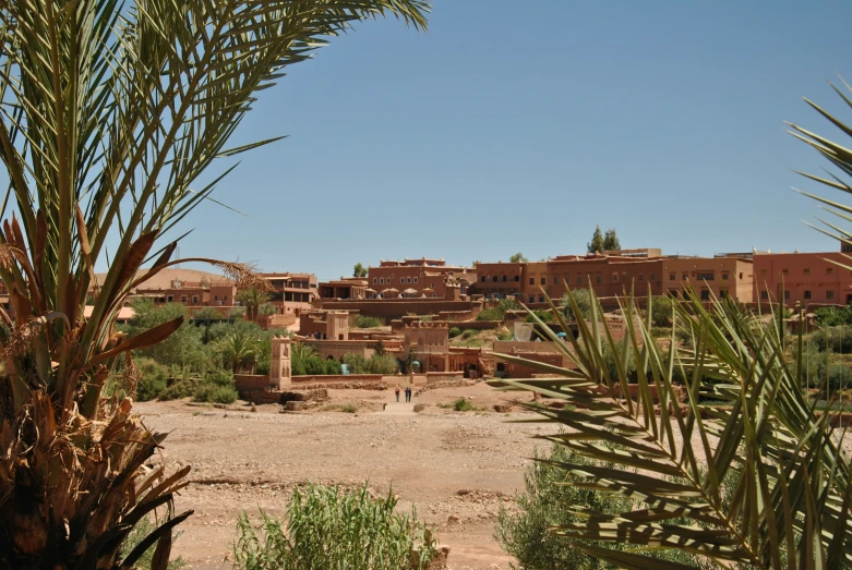 two people walking around in a desert village