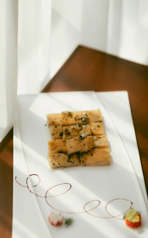 three pieces of food on a white plate