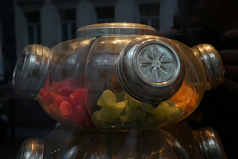 a glass jar with multiple gummy bears inside it