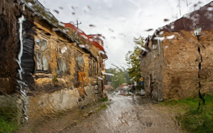 a street outside a small building in the rain