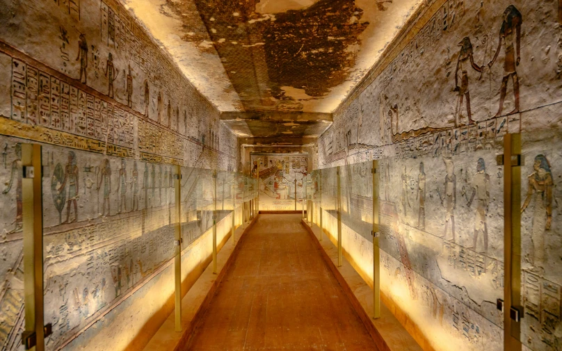 inside of an old tunnel with wall art and egyptian symbols