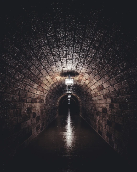 a dark tunnel in the middle of a street