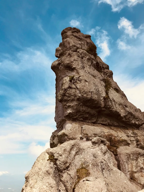 the big rock is tall and has rocks on it