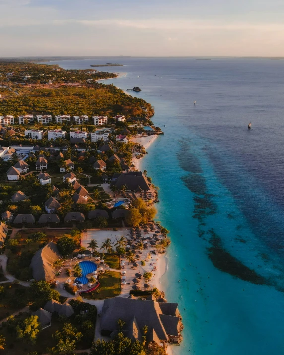 an aerial view of a long stretch of clear water and an island with homes