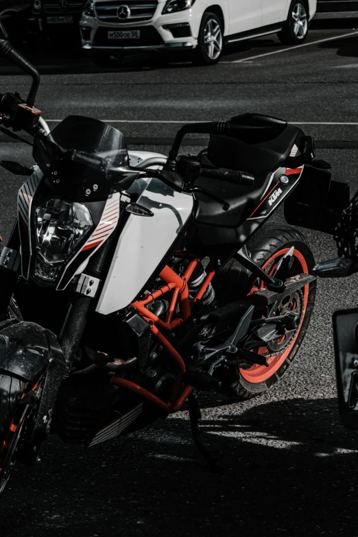 an orange and black motorcycle parked by itself