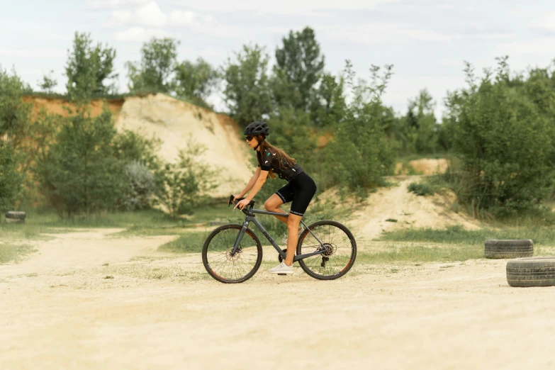 woman riding her bike on a dirt path