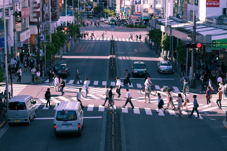 many people are crossing the street with their luggage