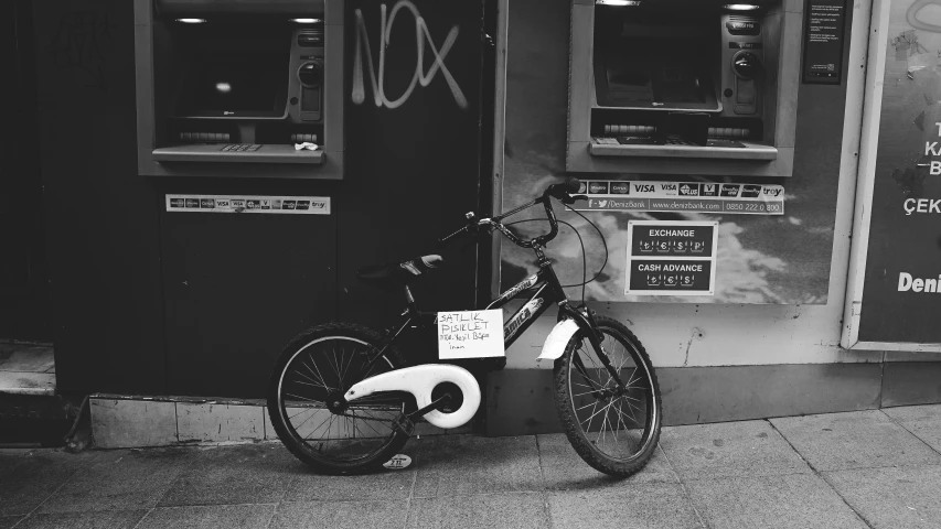 an old bike is sitting next to a shop