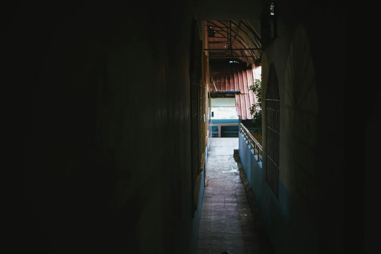 a narrow alley way leading to another alley