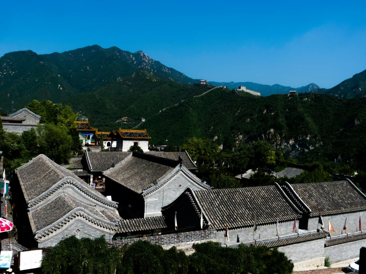 a large building with an arched roof in the mountains