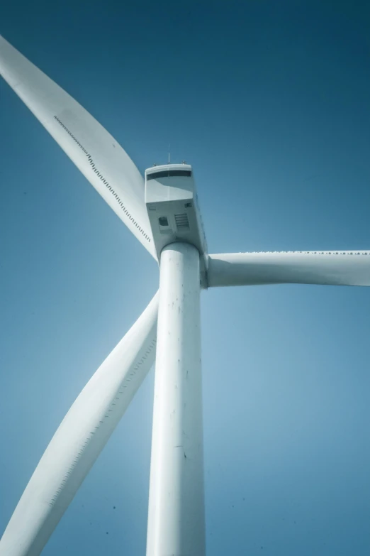 a wind turbine in the sky with a blue background