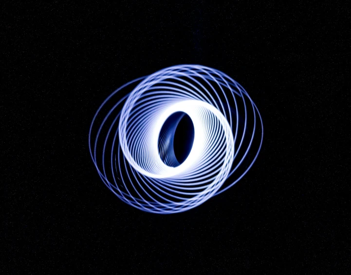 a white and blue circle on top of a dark background