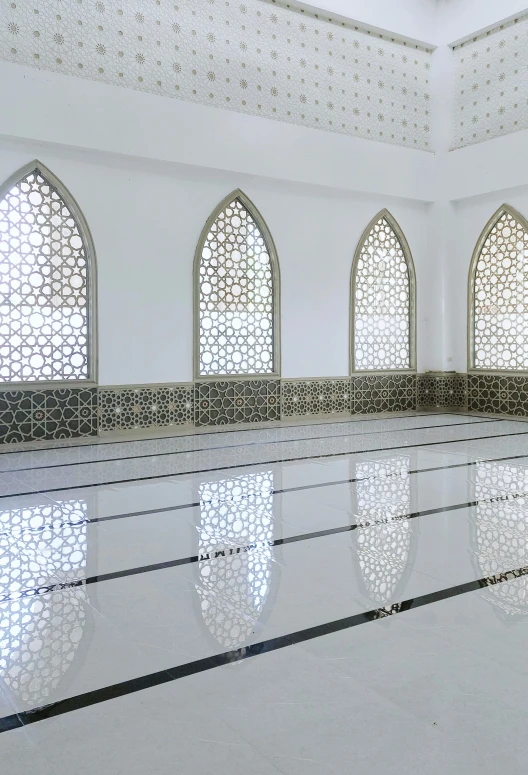 the interior of a large, elegant room with white marble floors and intricate design