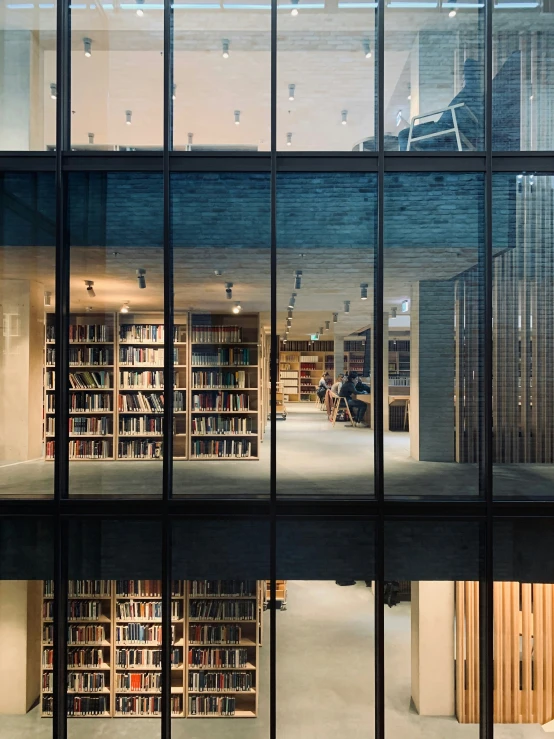 a large room with glass windows filled with books