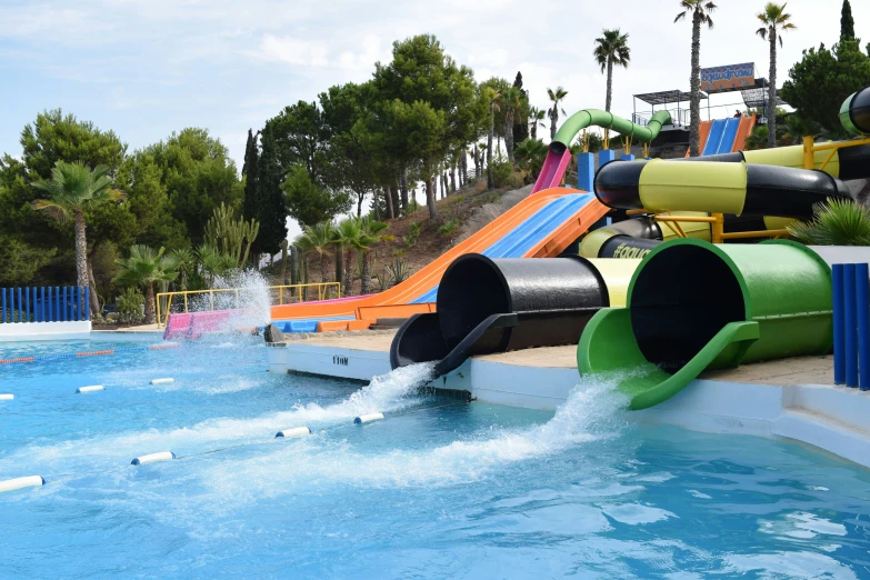 a small swimming pool with a slide and water slides