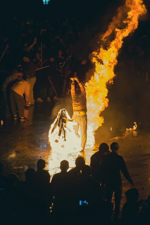 a crowd watching a fire show during a festival