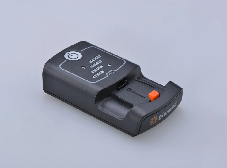 a po of a small black camera attached to a charger