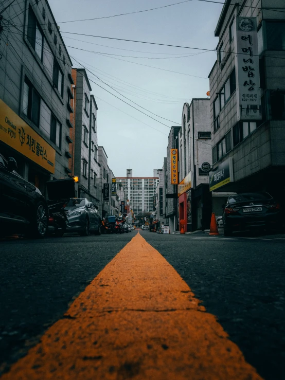 a street that has some cars parked on the sides of it