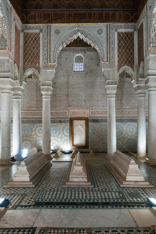 ornately decorated walls and columns and a doorway in a stone building