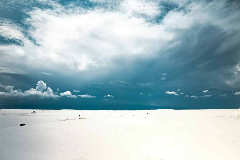 a lone snowboarder riding across the plain to reach the top