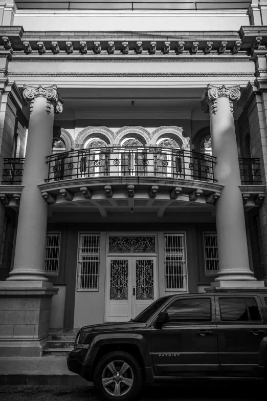 a black jeep parked in front of a building