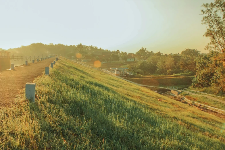 a long dirt road near a grassy field