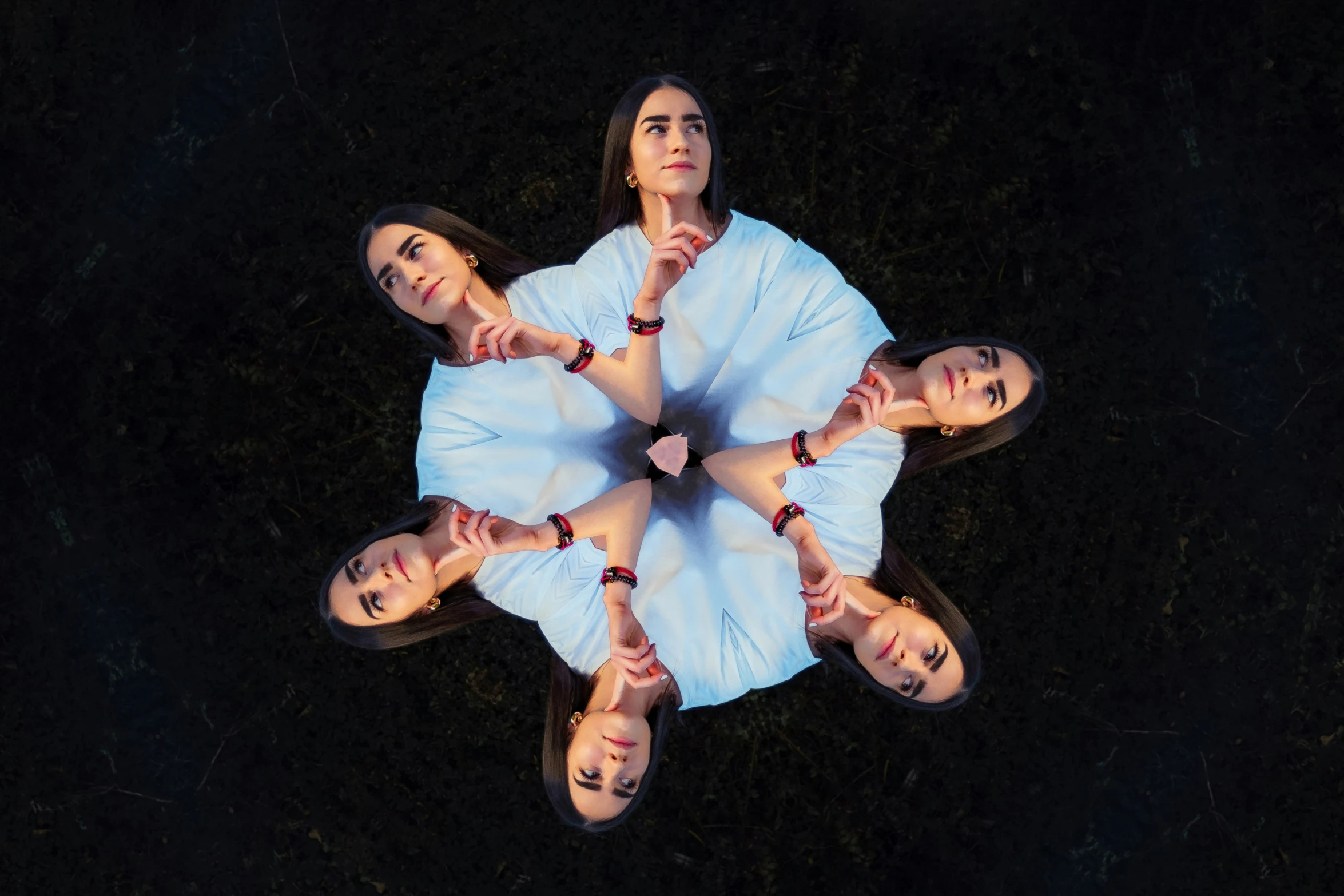 an aerial po of four girls, with hands together