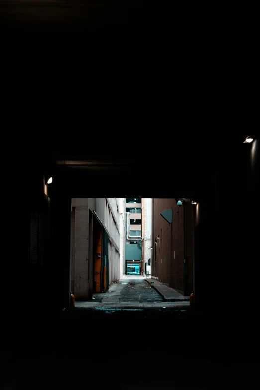 an alley with doors opened and a car parked on the sidewalk