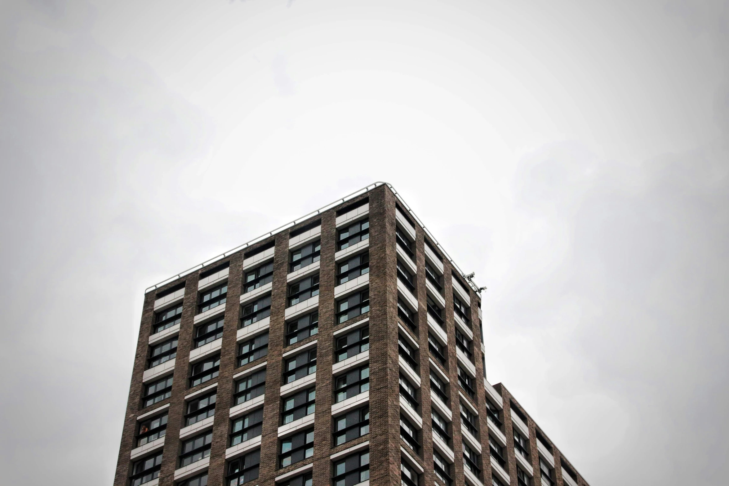 a large brown building with lots of windows