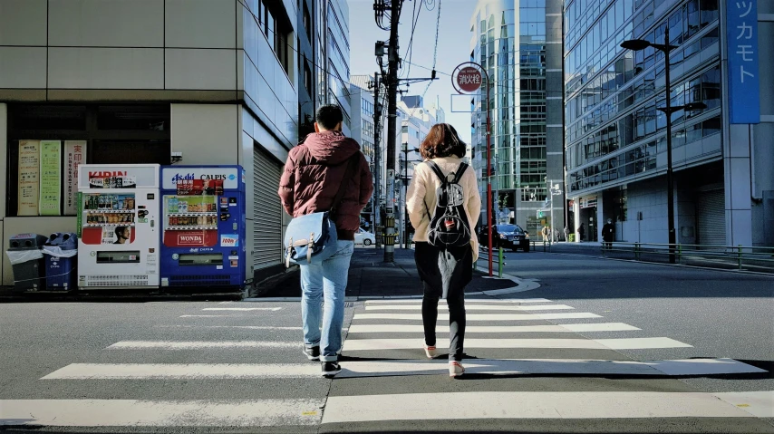 a man and woman walking on the side of a road
